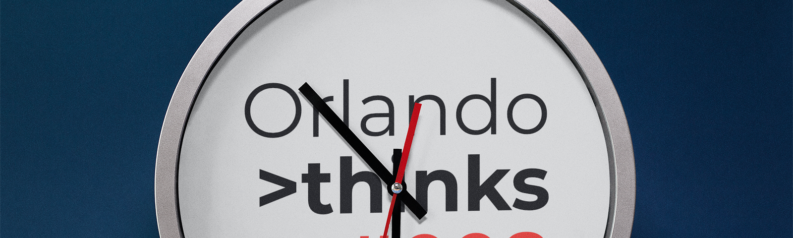 A clock showing the time 10:30. The background of the clock contains the words “Orlando thinks #008”