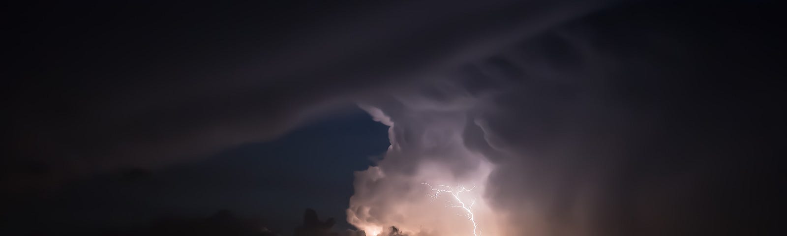 Lightning lights up a cloudy night