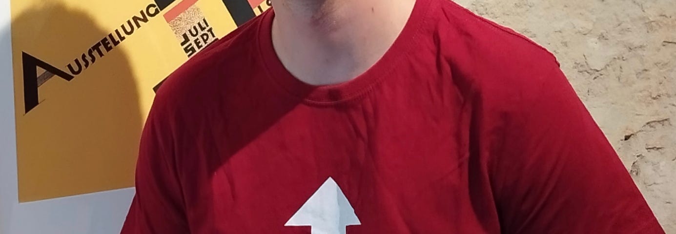 Author of the article wearing a red shirt with the following text : “Debugging IBC is such a Pain ! Talk to this guy” and an arrow from the text to the neck of the t-shirt