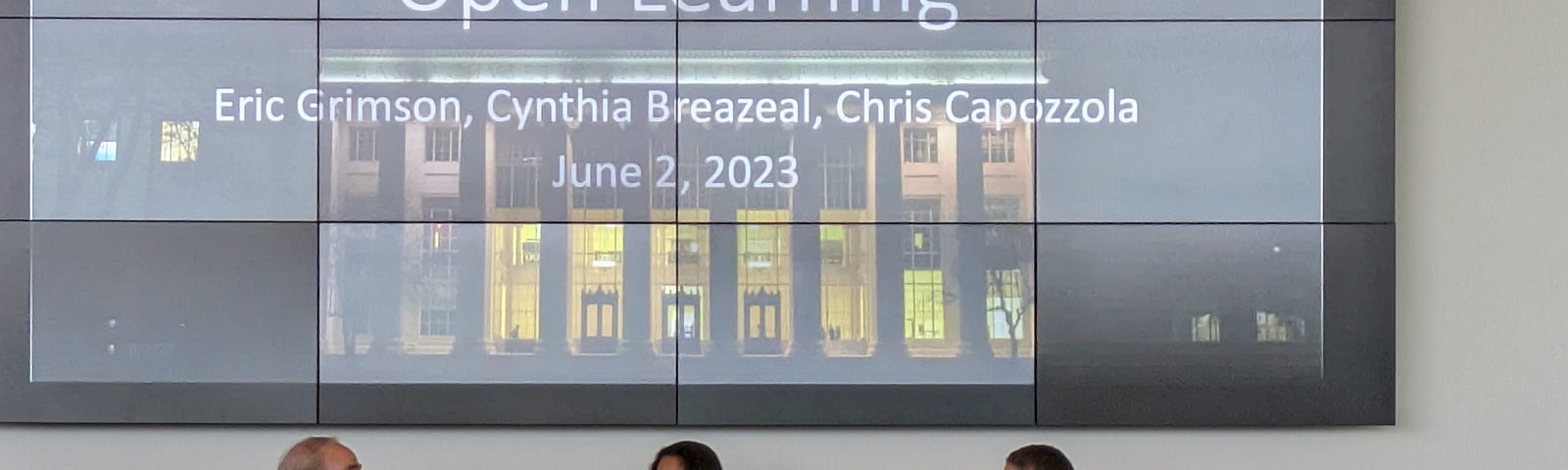 Three people seated in front of an audience, in front of a screen that says Open Learning, Eric Grimson, Cynthia Breazeal, Chris Capozzola, June 2, 2023