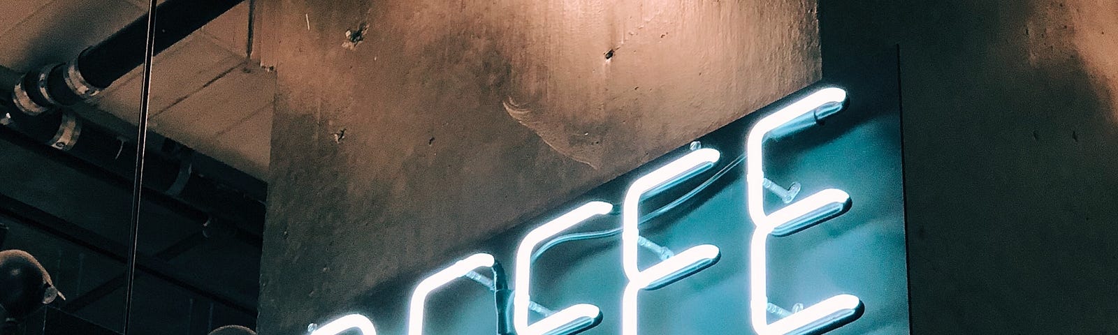 Neon florescent white color words spelling out COFFEE upon a metal blue sheet ; all held up against a large, thick wood beam for some kind of reasturant