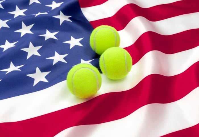 The American flag with three green tennis balls on top of it.