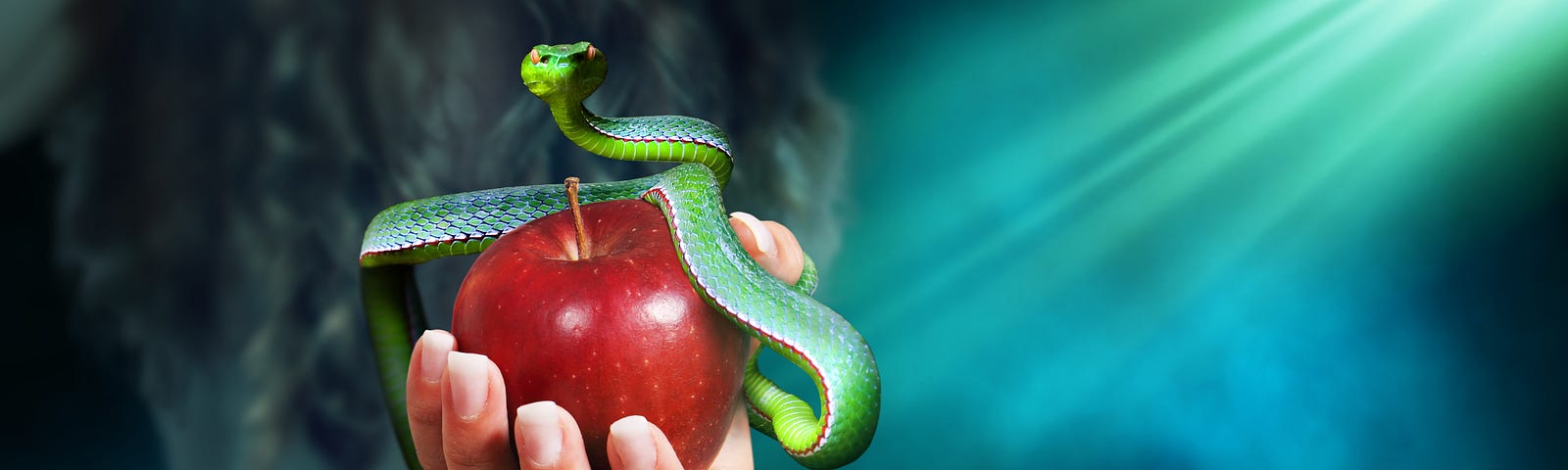 Hand holding an apple with a snake wrapped around iut