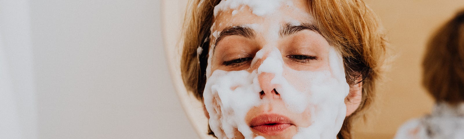 A woman with foamy facial wash on her face. Photo by Karolina Grabowska: https://www.pexels.com/photo/a-woman-with-foamy-facial-wash-on-her-face-5240368/