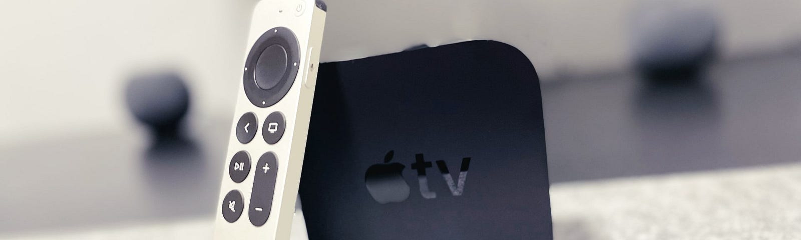 An Apple TV with Siri Remote on top of a desk