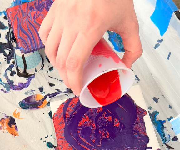 Paint Pouring with acrylic paint on ceramic tile.