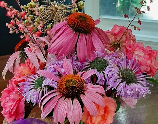 Picture of a bouquet with pink coneflowers, roses, and heuchera stalks