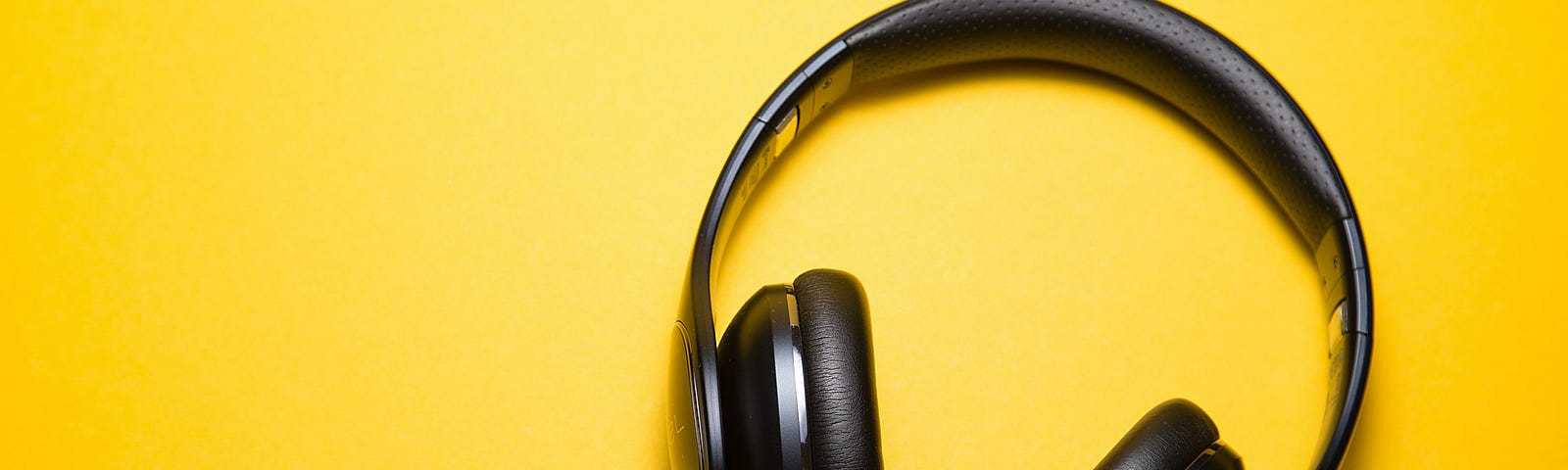 Black headphones on a yellow background