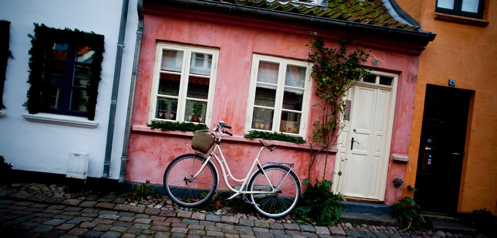 A danish row of homes with a bike.