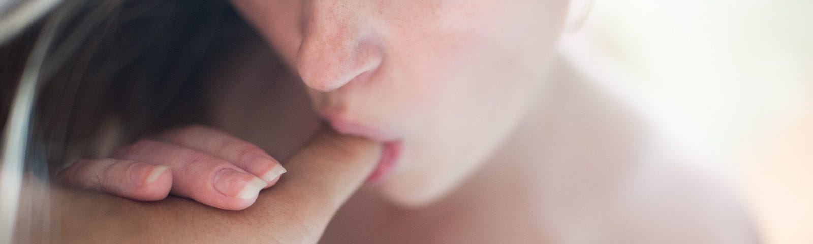 A girl sucking on a man’s thumb like she is giving him a blowjob for a tutorial on giving blowjobs. Better Sex.