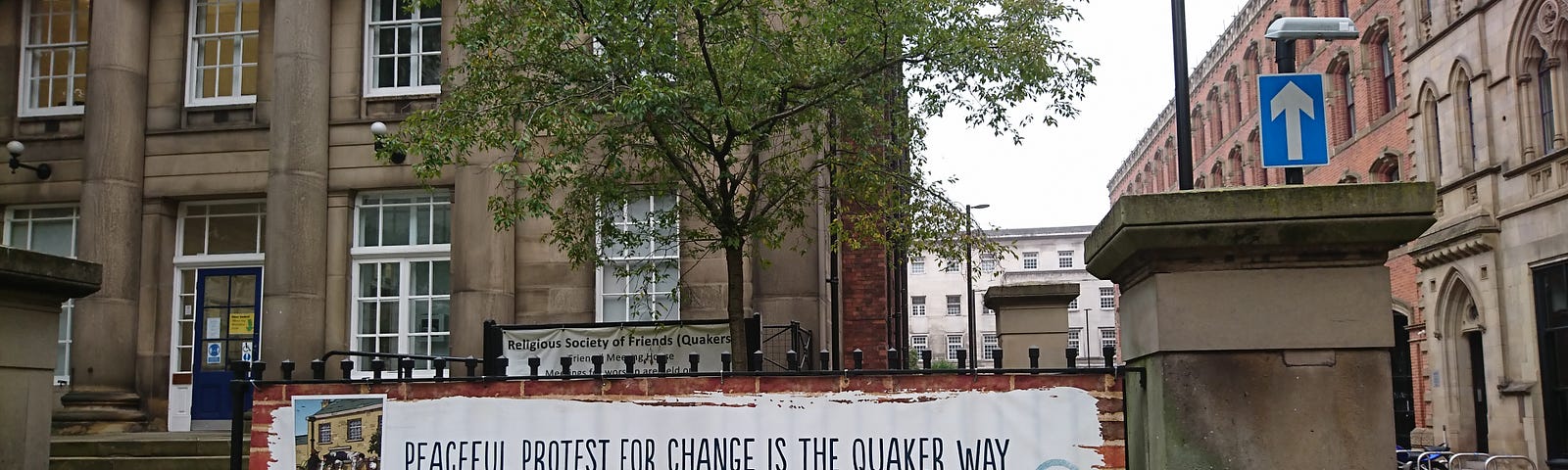 Banner outside Friends Meeting House, Manchester calling for peaceful protest