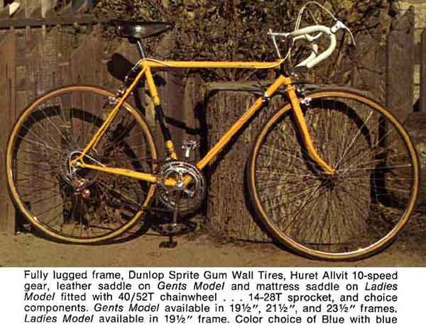 Photo of a racing style bike in orange leaninig against some wooden fence looks very 1970's