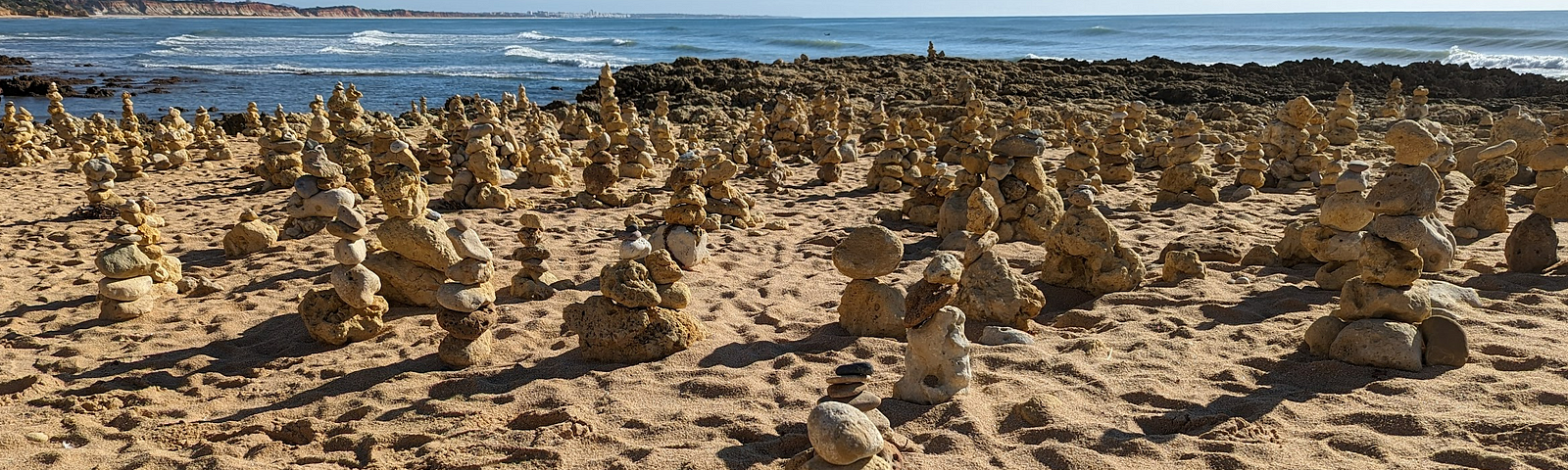 Many rock stacks on a beach