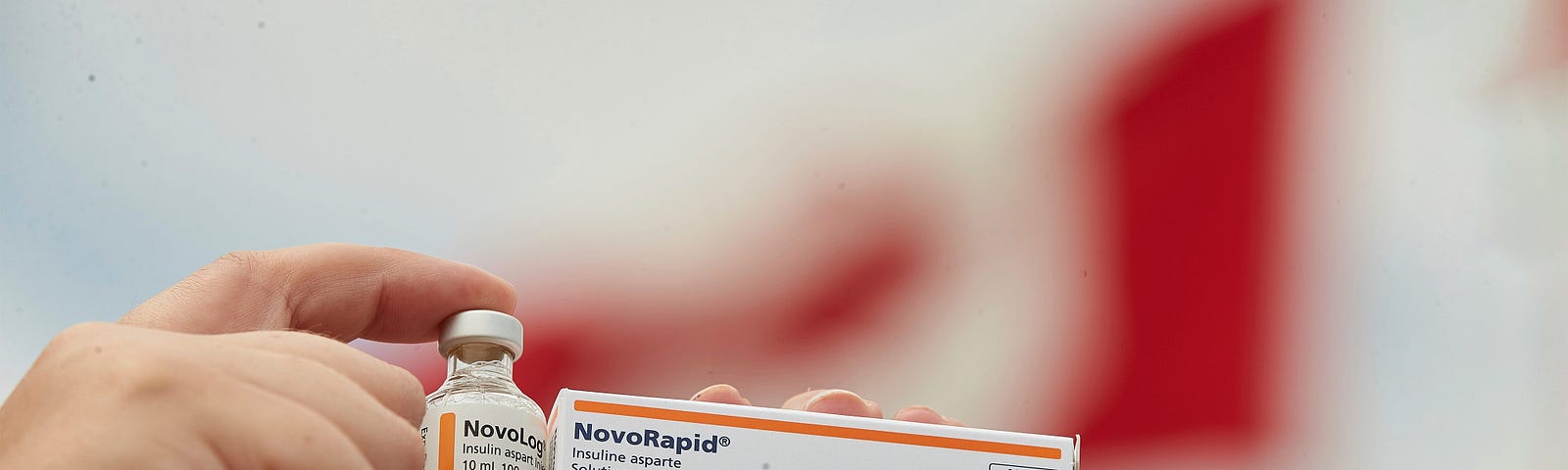 A woman from MN holds up U.S. and Canadian insulin,  June 29, 2019. Photo by Geoff Robins/The Canadian Press via AP