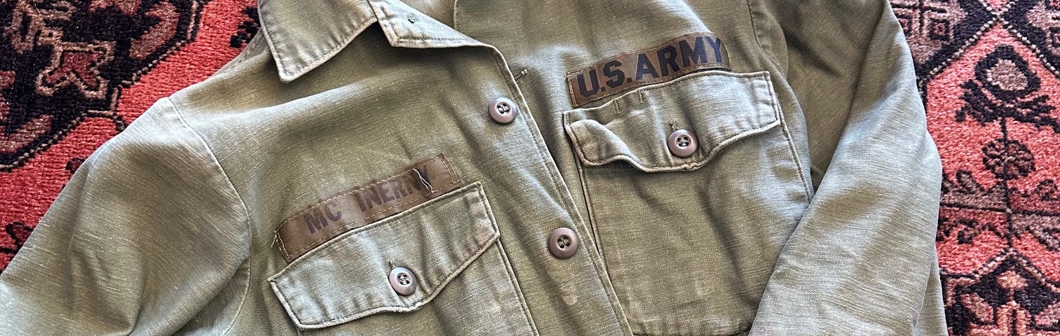 Picture of a tattered Army jacket with the name McInerny printed over a breast pocket