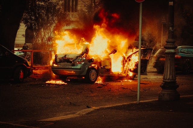 Picture of a car burning in the street