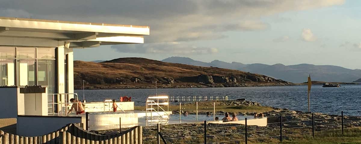 Outdoor pool by the loch at a resort spa