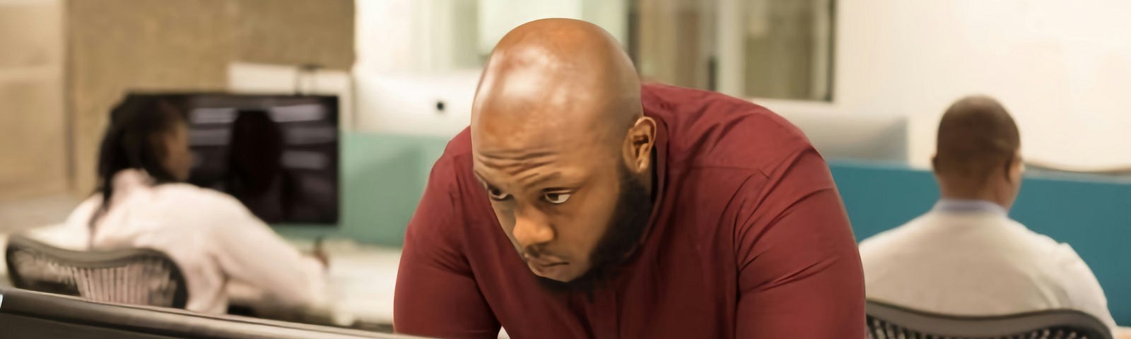 A guy staring at the computer monitor.