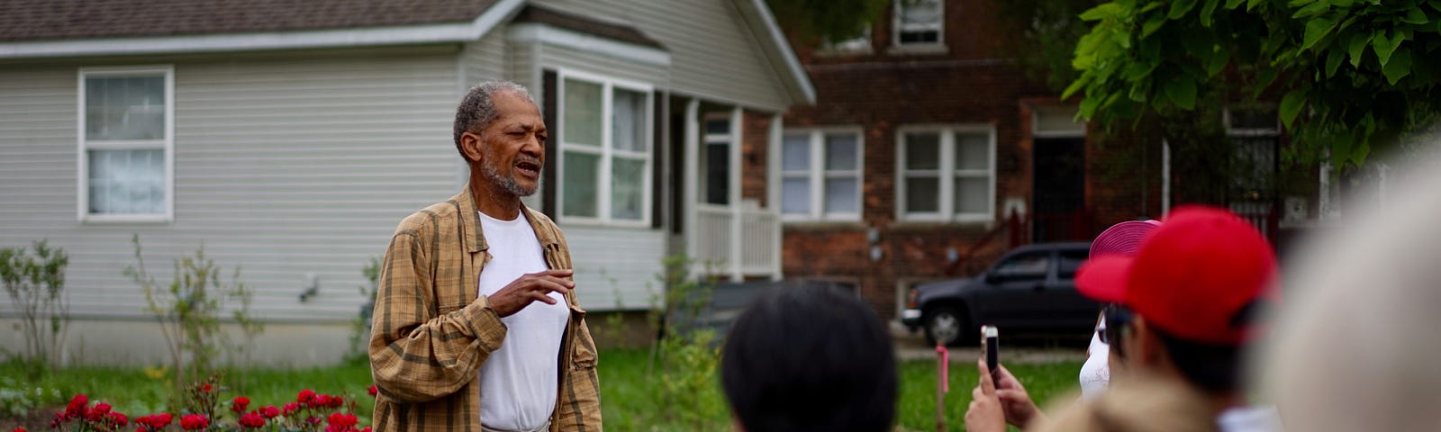 An aspiring entrepreneur leading a neighborhood tour during the Detroit Neighborhood Tours project.