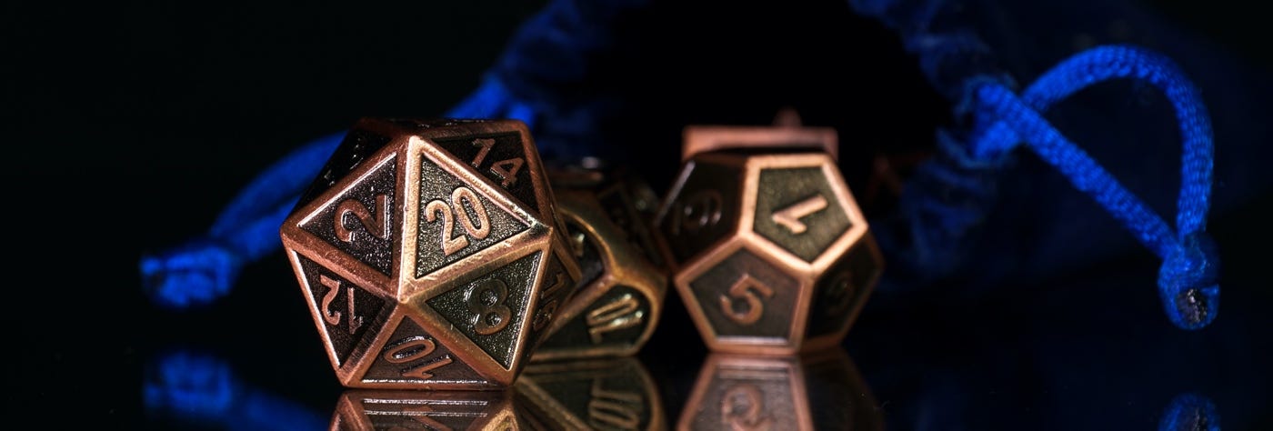 Image: A copper d20 and d12 against a dark background.