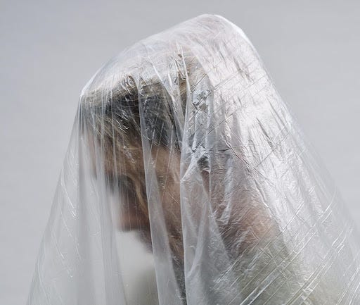 clear plastic sheet over a persons head