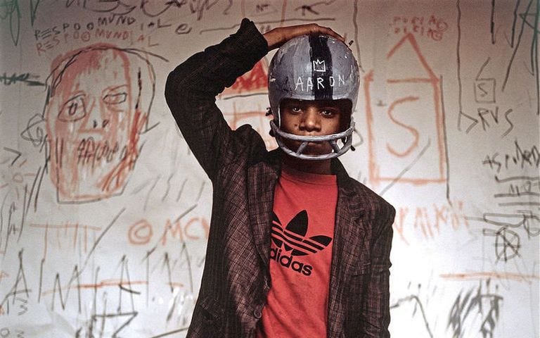 Jean-Michel Basquiat wearing an American football helmet (1981). Photo: © Edo Bertoglio, courtesy of Maripol, Artwork