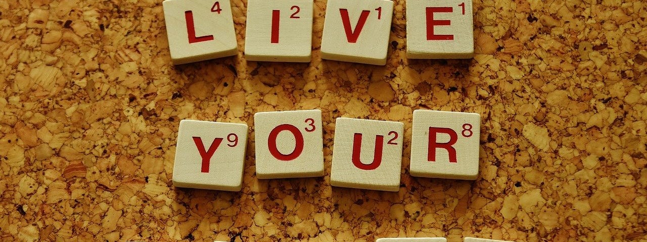 live your dream spelled out with scrabble tiles