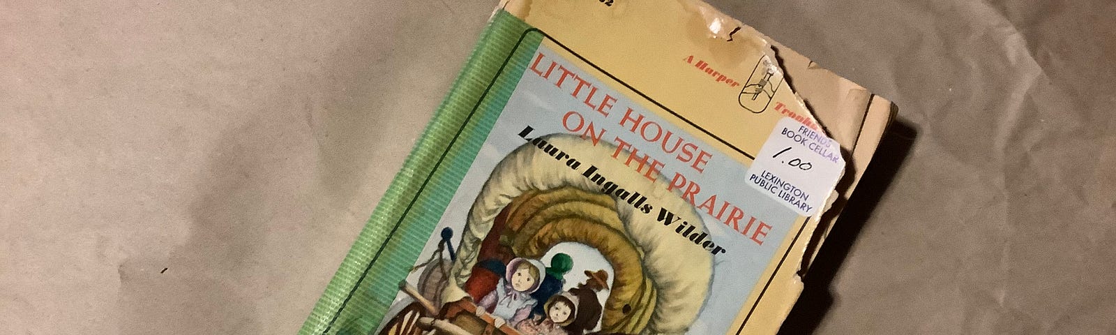 battered library discard of Laura Ingall’s Wilder’s Little House on the Prairie, a novel that brings American history and pioneer spirit to vivid life