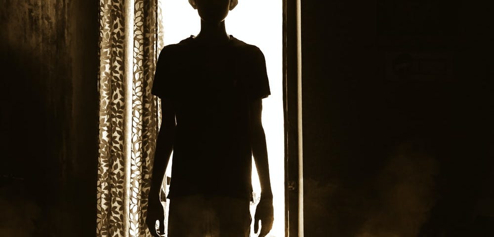 Shadow man in a doorway