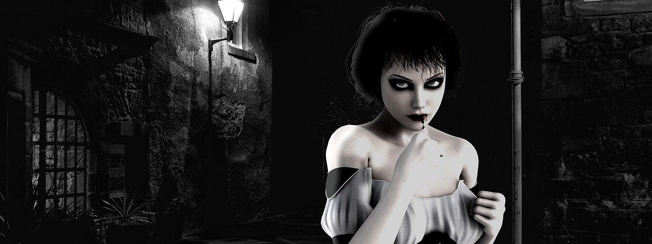 Image of a goth-like woman in a dark fantasy-like alley at night, complete with what looks like a dungeon entrance on the left. Some blood is dripping from her lips.