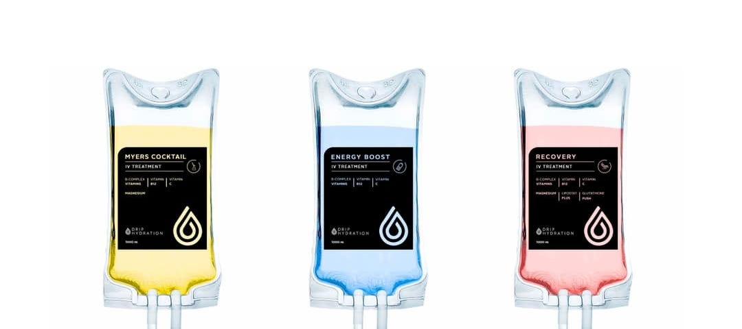 Three IV bags of vitamin cocktails with different labels: Myers Cocktail, Energy Boost, and Recovery.