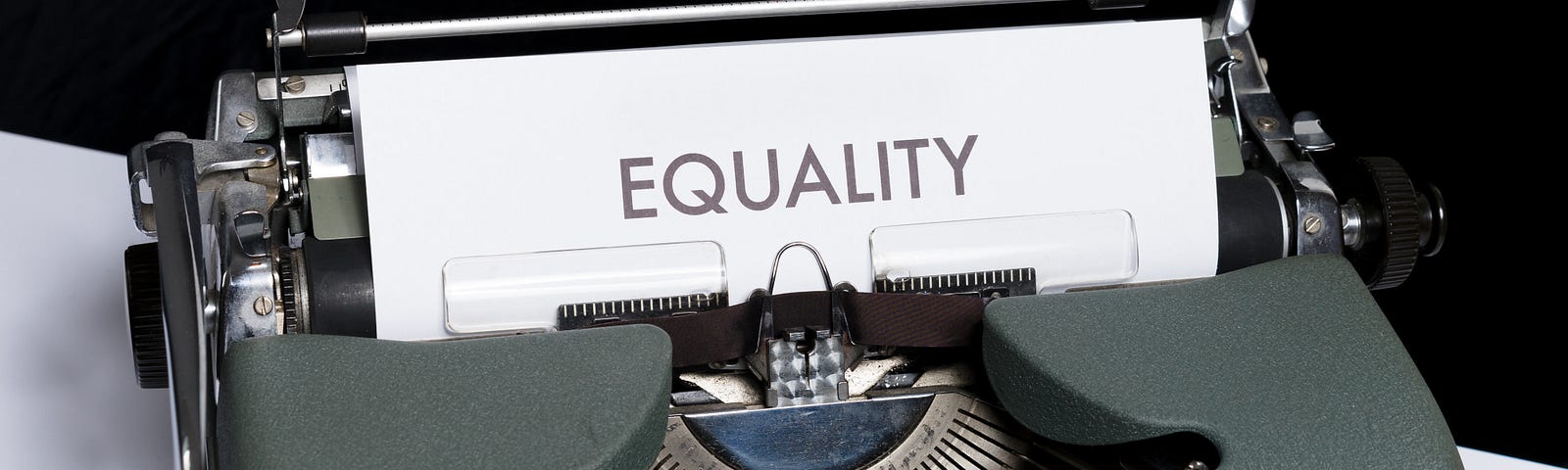 type writer with a page coming out that reads “EQUALITY”