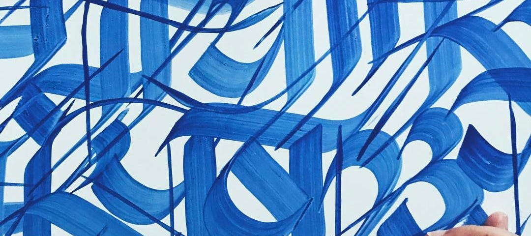 A work in progress of blue, graffiti-style Nepali calligraphy by Imagine, a Nepali artist based in Boston, MA.