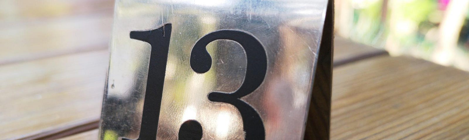 The number 13 written in black on a metal placeholder.