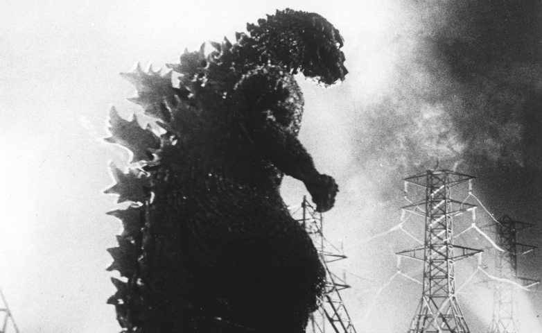 A reptilian monster, Godzilla, is stomping on electric power stations. He is huge and has glowing spikes going down his back. Godzilla, movie reviews, film, classic, horror, science fiction, Japan