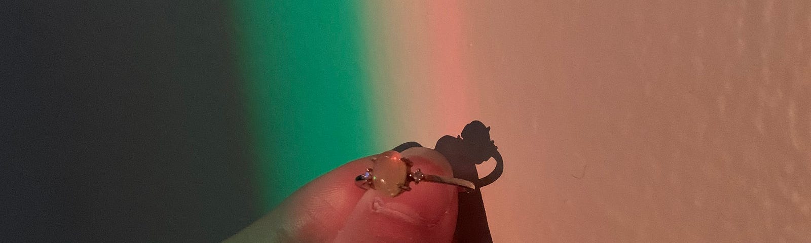 I am holding the opal ring my ex gave me for my birthday 3, almost 4 years ago. She had a matching one with a silver band, while mine was gold.