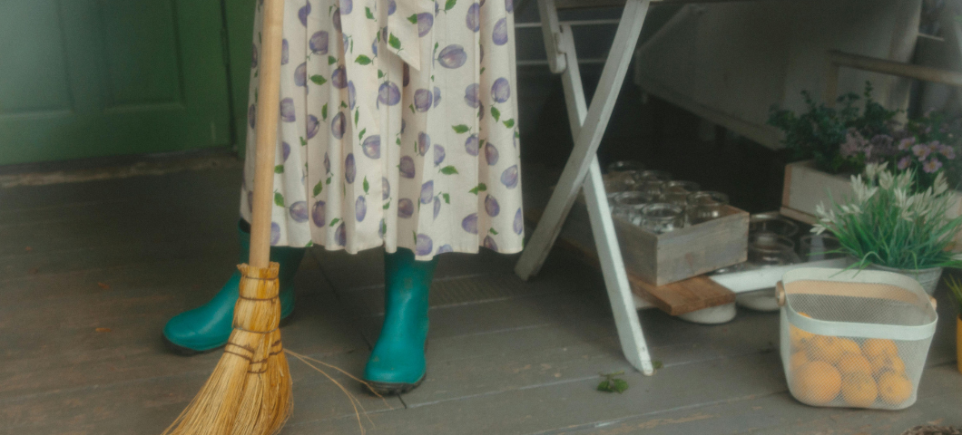 a woman sweeping a floor