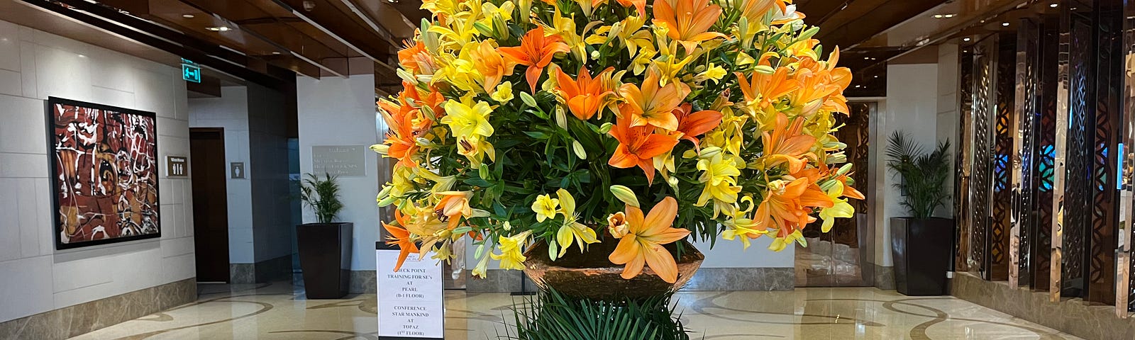 Lobby of the hotel, with yellow flowers.