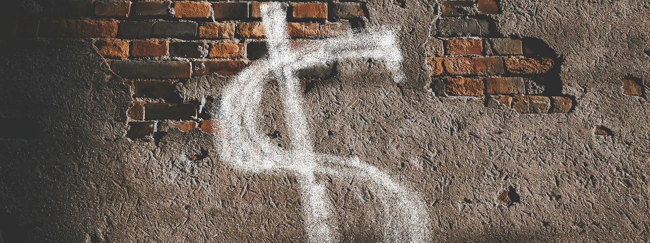 Photo of a dilapidated brick wall with a dollar sign spray painted on it.