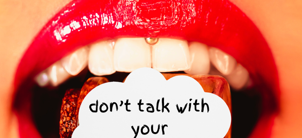 womans red lips open with teeth showing. Talk bubble inside mouth reading “Don’t walk with your mouth full”