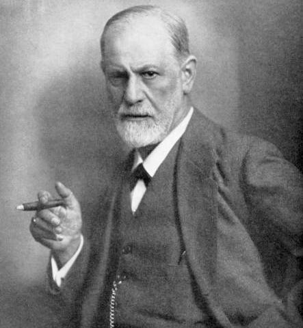 Photo of Dr. Sigmund Freud, standing, holding lit cigar