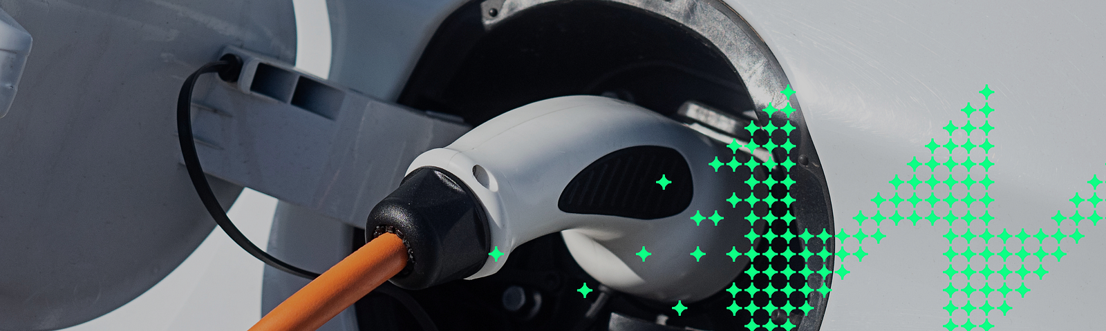 Photo of an electric vehicle plug while charging the car. To the right side of the photo, a graphic element is overlaid; it is a group of individual bright green nodes that come together to form a zig-zag pattern off the right side of the photo.