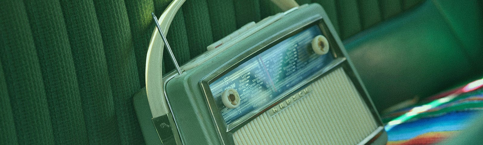 Vintage radio on the back of a vintage car.