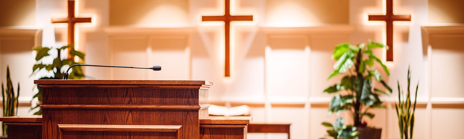 brown wooden cross on brown wooden pulpit