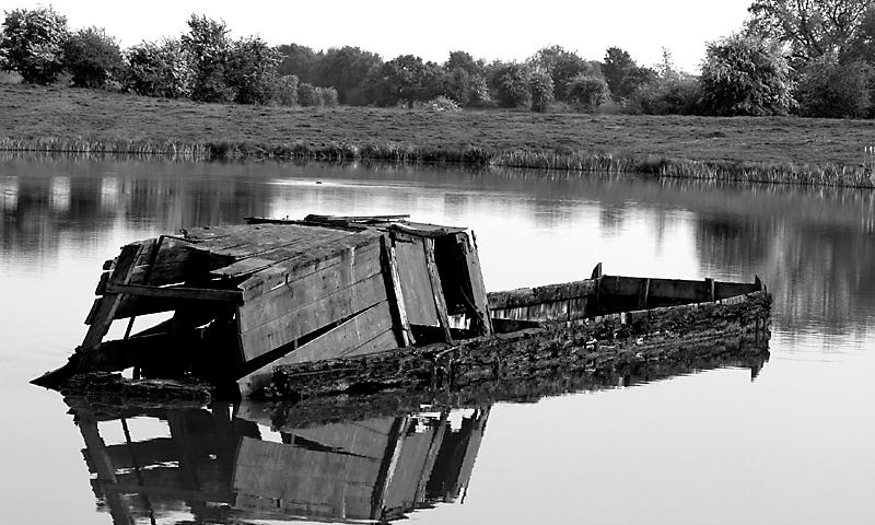 A wrecked narrowboat on a British canal