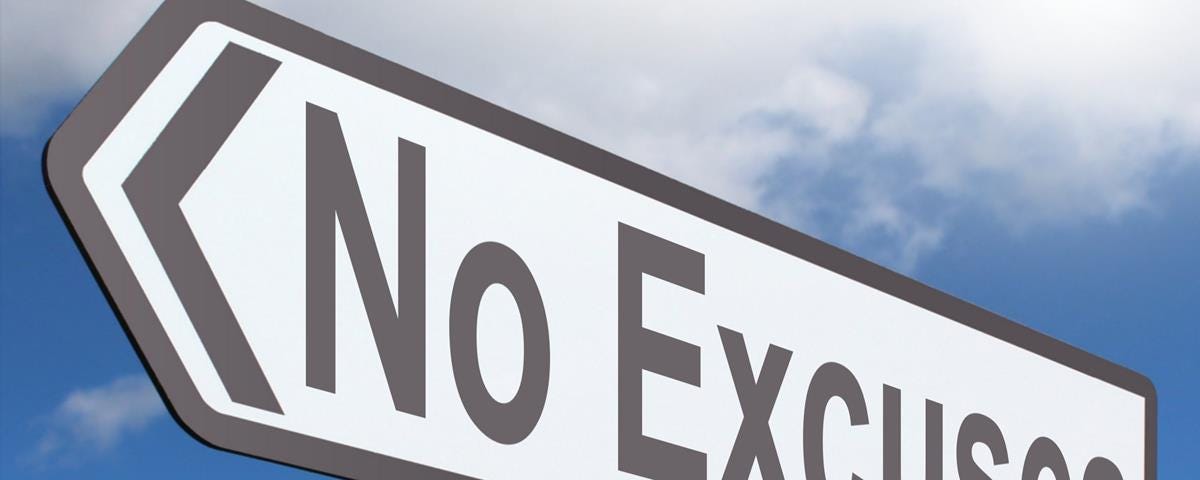 A road sign pointing with the word No Excuses on it. In the background is a blue sky and a fluffy white cloud