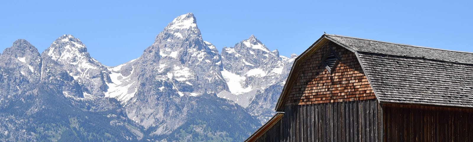 old barn in front of mountains