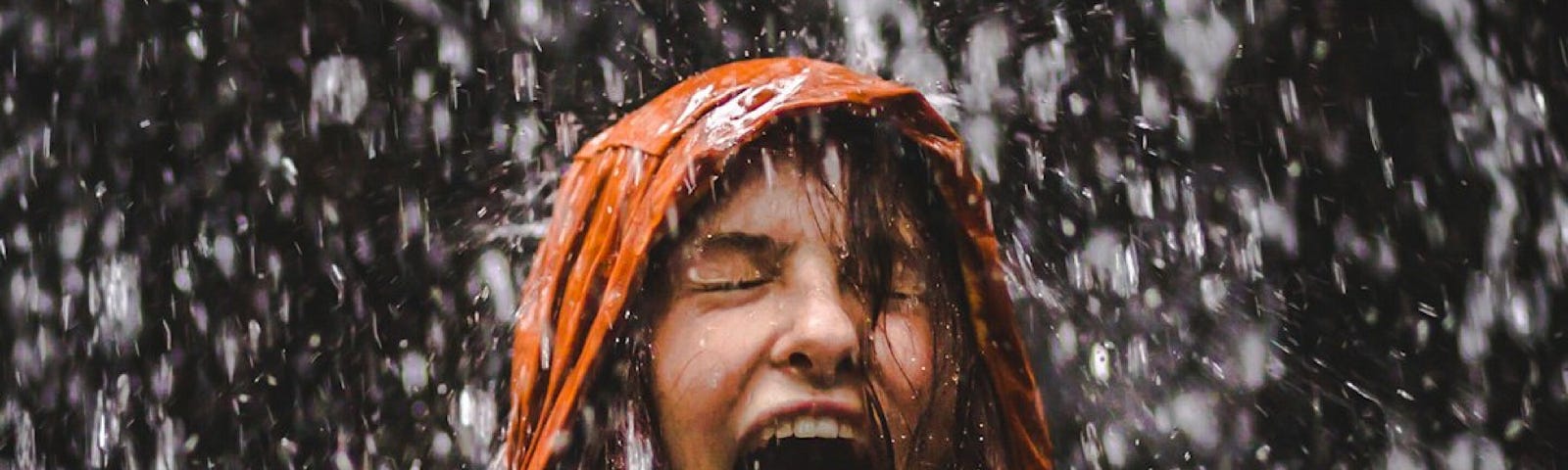 picture of a girl getting soaked in the rain without an umbrella