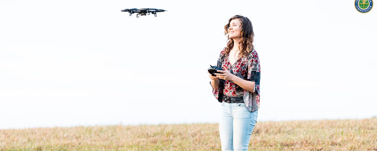 A woman flying a drone.