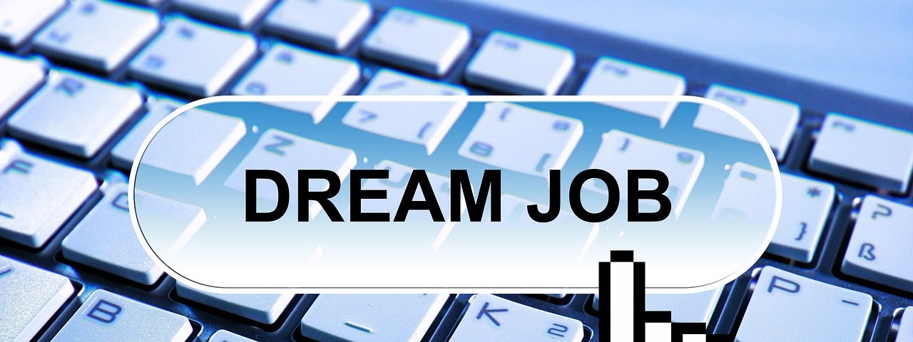 Bluish-white image with a keyboard partially visible, and hovering over that a button with the text: DREAM JOB.